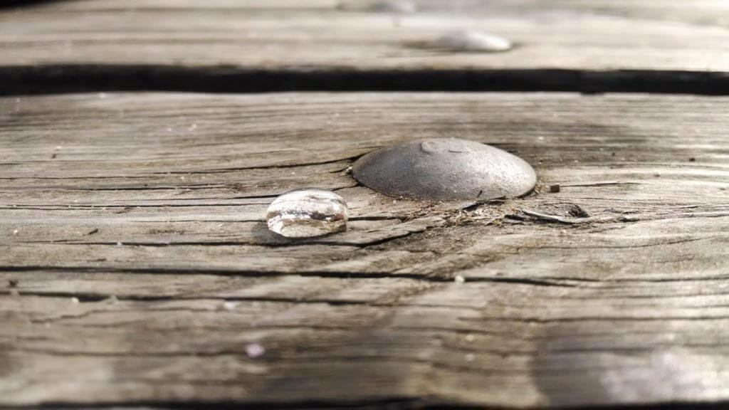 A drop of rain on a wooden table